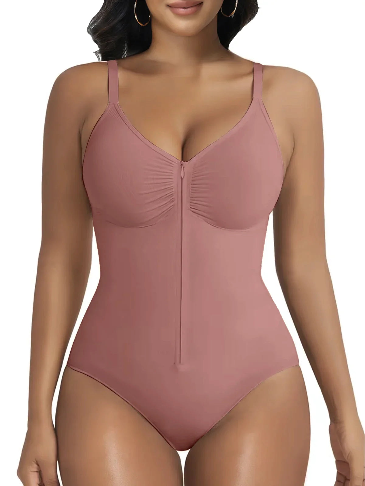 Woman wearing mauve zip-front sculpting bodysuit by Formivelle, adjustable straps, white background