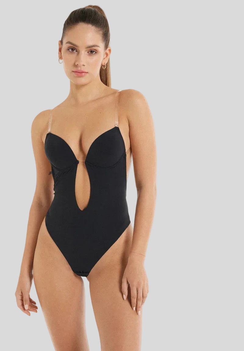Woman wearing a black swimsuit with a cutout design on a white background