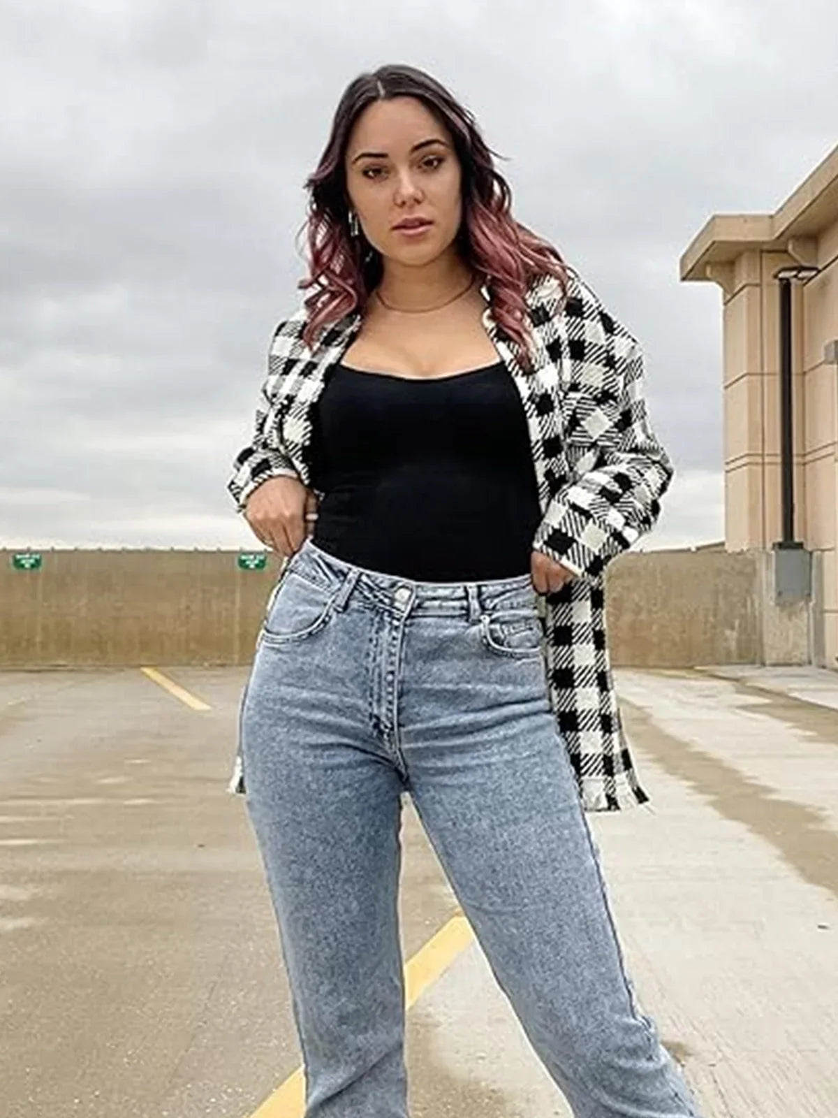 Woman wearing black sculpting bodysuit and plaid jacket, Formivelle shapewear, outdoor setting