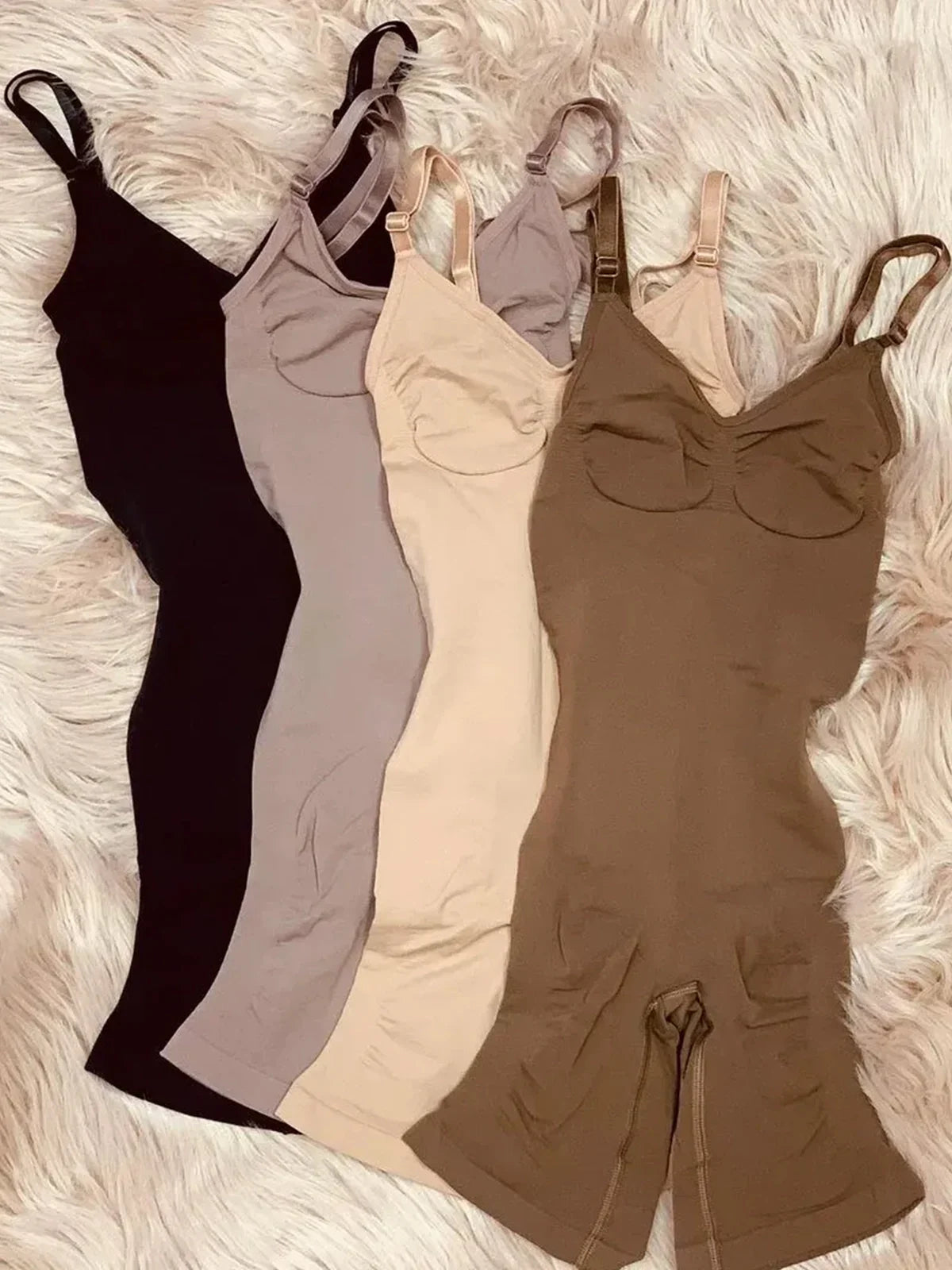 Formivelle sculpt and smooth mid-thigh bodysuits in four neutral colors on faux fur background