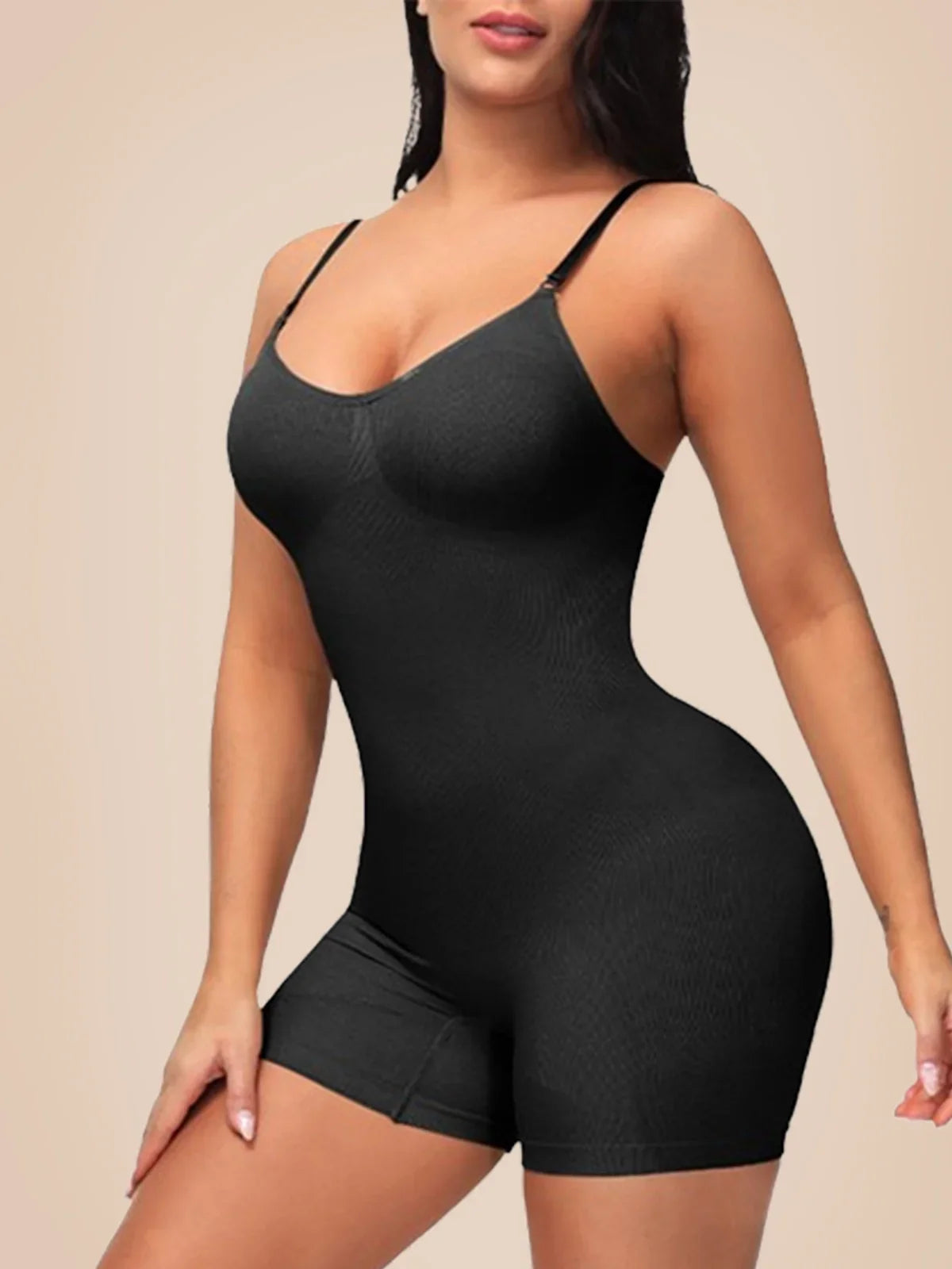 Woman wearing Formivelle black mid-thigh sculpting bodysuit shapewear against beige background