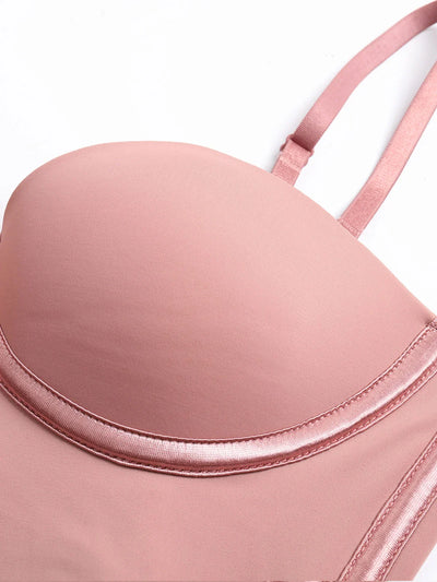 Close-up of pink Formivelle push-up corset bodysuit with soft satin trim and adjustable strap