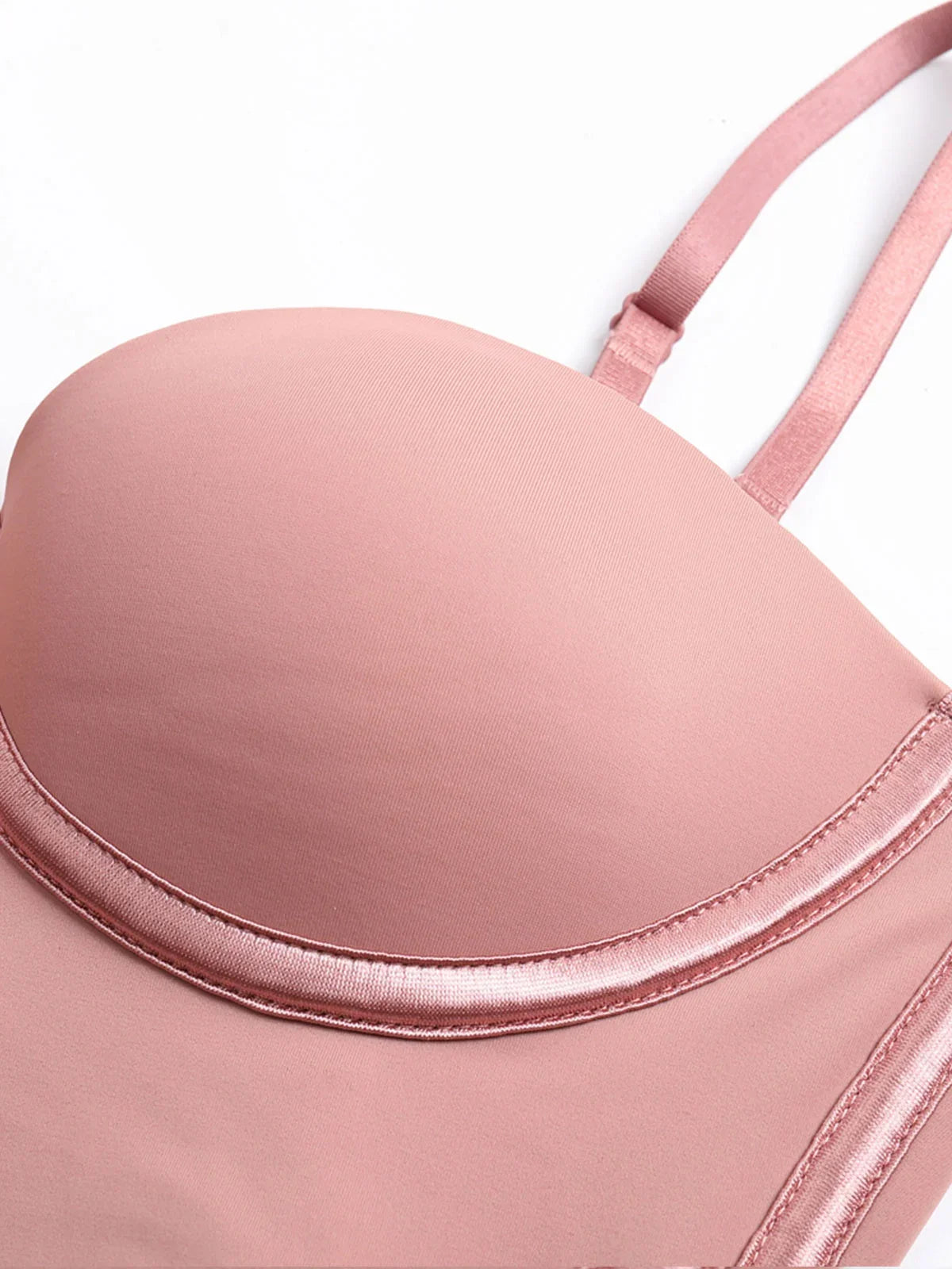 Close-up of pink Formivelle push-up corset bodysuit with soft satin trim and adjustable strap