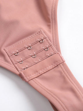 Close-up of Formivelle pink shapewear bodysuit snap closure, soft stretch fabric detail