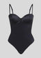 Formivelle black push-up corset bodysuit with adjustable straps on beige background