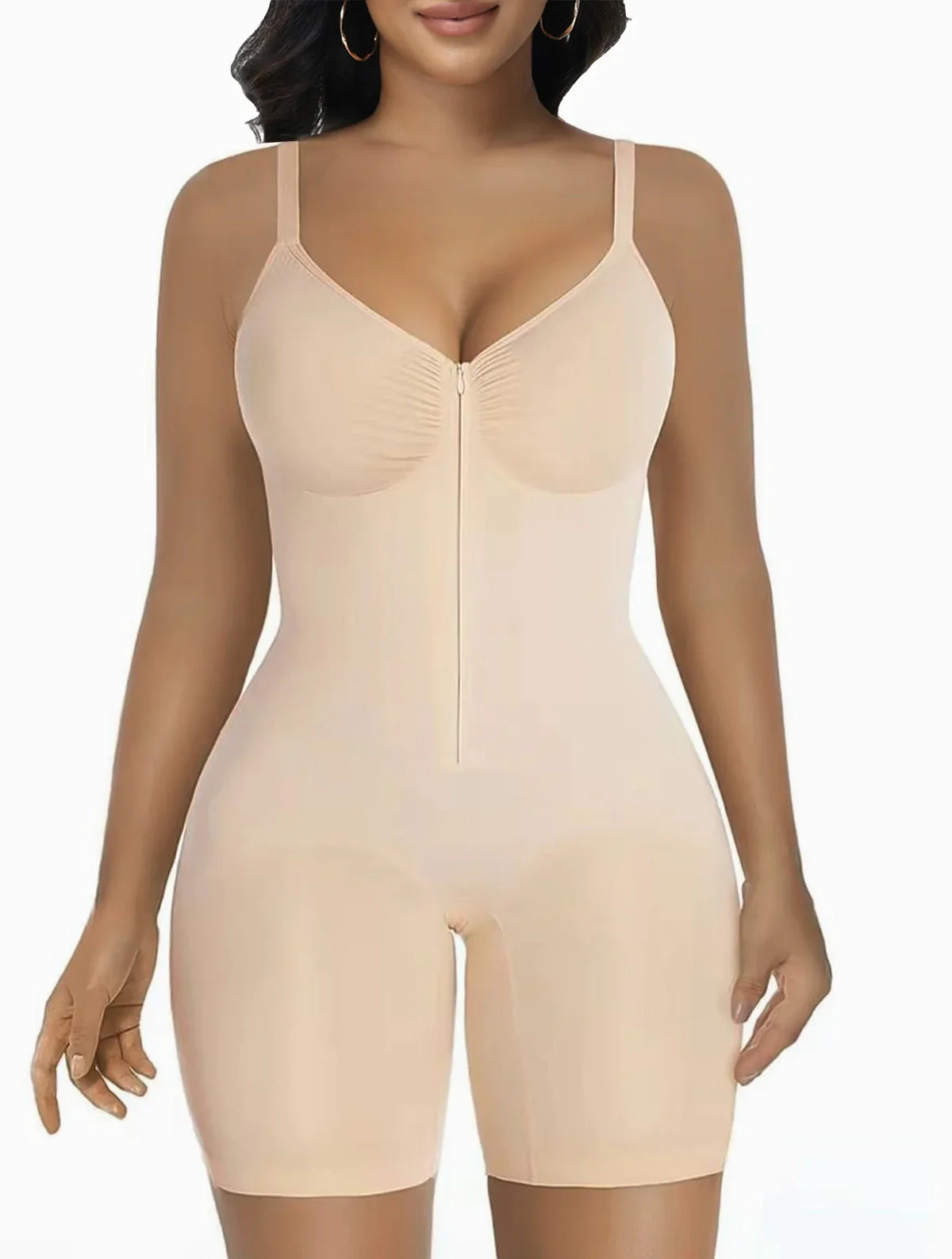 Woman wearing a nude zip-front sculpting bodysuit by Formivelle against a white background