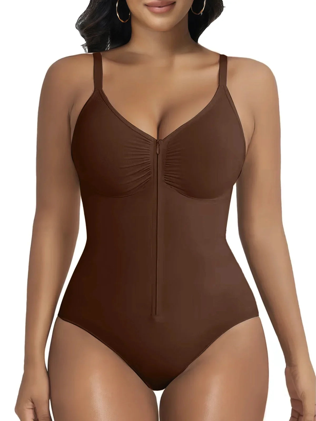 Woman wearing a brown zip-front sculpting bodysuit by Formivelle against a white background